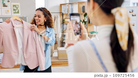 Fashion influencer, cellphone and women live streaming clothes presentation, style review or mobile app broadcast. Phone, content creator team and small business owner teamwork on retail commercial 109725456