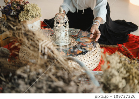 Women's circle and the practice of using metaphorical cards. The girl's hands are holding cards Women's circle and the practice of using metaphorical cards. The girl's hands are holding cards 109727226