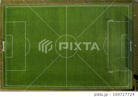 Top view of a football field with green grass outdoors in summer Top view of a football field with green grass outdoors in summer 109727724