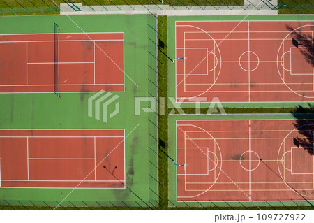 View from the height of the empty Tennis courts in the daytime in summer View from the height of the empty Tennis courts in the daytime in summer 109727922