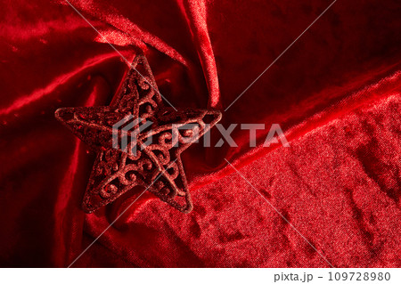 Abstract Christmas background with star on a red velvet background. Abstract Christmas background with star on a red velvet background. 109728980