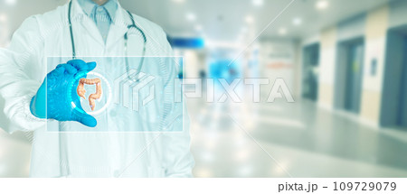 Doctor touching scan to check patient's colon with monitor 109729079