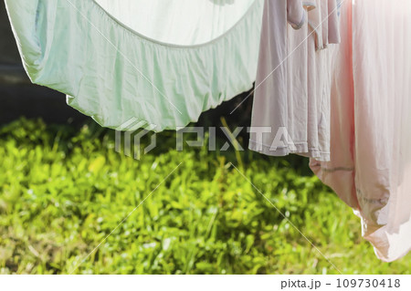 Clean washed laundry hanging on the rope outdoors. Clean washed laundry hanging on the rope outdoors. 109730418