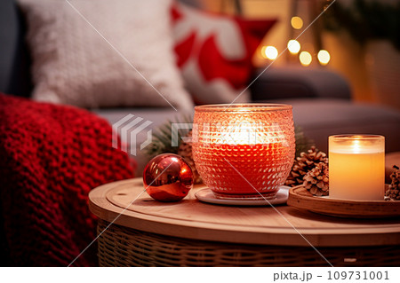Burning candle in cozy living room on Christmas Eve. Cozy home concept. Selective Focus 109731001