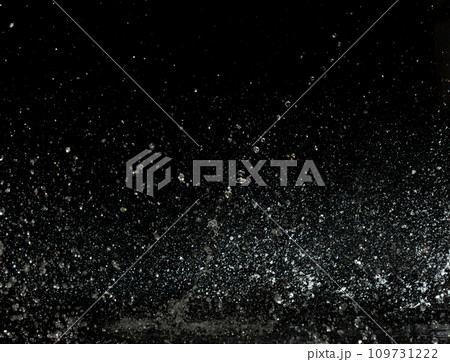 Throwing of Water splashes into drop water attack fluttering in wall floor and stop motion freeze shot. Splash Water for explosion texture graphic resource elements, black background isolated 109731222