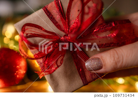 Christmas gift or present box, against magic bokeh background. Beautiful Christmas gift boxes with ribbon Christmas gift or present box, against magic bokeh background. Beautiful Christmas gift boxes with ribbon 109731434