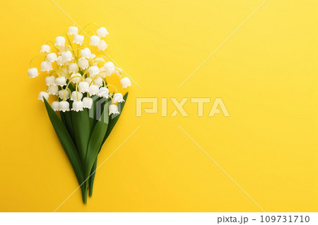 Lily of the valey bunch on yellow background top view 109731710