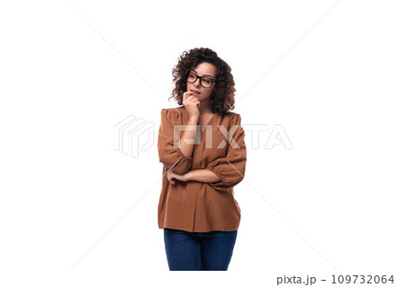 young pensive caucasian lady with curly hair is wearing a brown blouse young pensive caucasian lady with curly hair is wearing a brown blouse 109732064