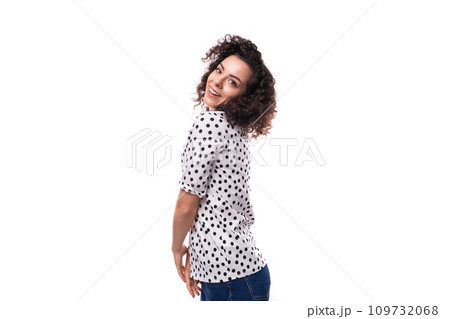young well-groomed brunette curly woman dressed in a blouse with a pattern of peas 109732068