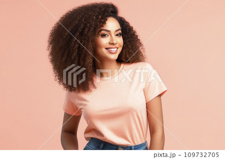 T-shirt mockup on smiling african american woman with curly hair isolated on peach fuzz background. Trending color concept of the year 2024 Peach Fuzz. T-shirt mockup on smiling african american woman with curly hair isolated on peach fuzz background. Trending color concept of the year 2024 Peach Fuzz. 109732705