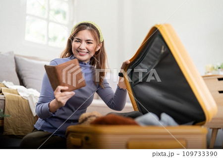 Woman packing suitcase for a new journey packing list for travel planning. prepare vacation. traveling 109733390