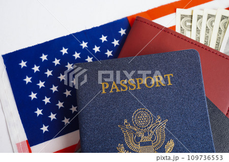 US passport on USA flag, American citizen in United States of America. US passport on USA flag, American citizen in United States of America. 109736553