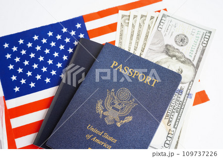 US passport with dollar money on USA flag, American citizen in United States of America. 109737226