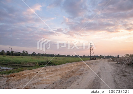 Construction site with crane at sunset Construction site with crane at sunset 109738523