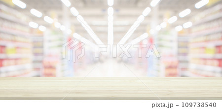 Wood table top with supermarket grocery store blurred background with bokeh light for product display Wood table top with supermarket grocery store blurred background with bokeh light for product display 109738540