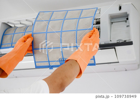 Asian man cleaning air conditioner dirty filter Asian man cleaning air conditioner dirty filter 109738949