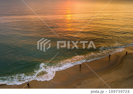 It s sunny morning fisherman is catching fish on ocean during sunrise It s sunny morning fisherman is catching fish on ocean during sunrise 109739728