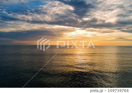 In morning sun rises over water waves of ocean 109739768