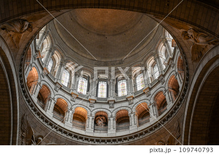 Paris, France, July 1 2022. Fascinating photo of the interior of the dome of the Sacre Coeur Basilica. The scene is illuminated by the natural light that filters through the windows. 109740793
