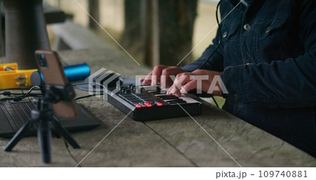 Man uses digital electric piano to create music outdoors Man uses digital electric piano to create music outdoors 109740881