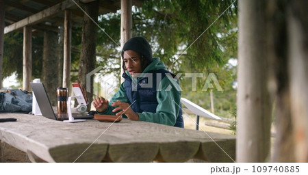 Tourist remotely studies during holidays in mountain forest 109740885