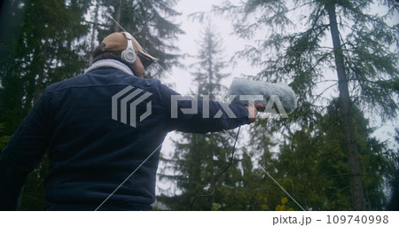 Caucasian man works with professional audio equipment outdoors 109740998