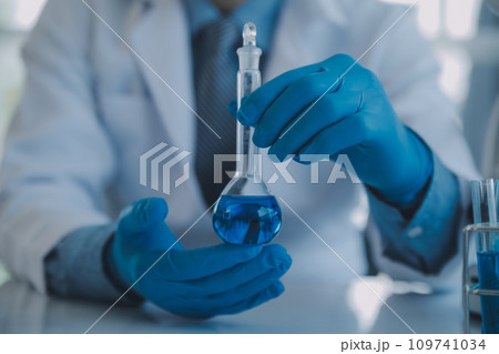 biochemical research scientist team working with microscope for coronavirus vaccine development in pharmaceutical research labolatory, selective focus biochemical research scientist team working with microscope for coronavirus vaccine development in pharmaceutical research labolatory, selective focus 109741034