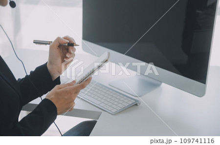 Beautiful female call center operator working on computer in office 109741116