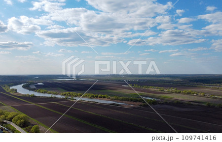 Plowed fields on the banks of the river. Aerial view. 109741416