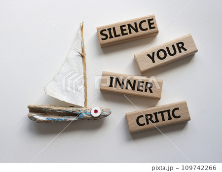 Silence your inner critic symbol. Wooden blocks with words Silence your inner critic. Beautiful white background with boat. Business and Silence your inner critic concept. Copy space Silence your inner critic symbol. Wooden blocks with words Silence your inner critic. Beautiful white background with boat. Business and Silence your inner critic concept. Copy space 109742266