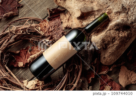 Bottle of red wine with a blank old label. 109744010