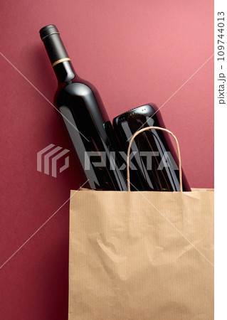 Paper shopping bag with bottles of red wine. Paper shopping bag with bottles of red wine. 109744013