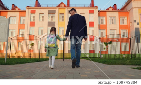 kid child holds father hand, daddy little schoolgirl going class backpack, family. happy family, father leads girl daughter by hand school, happy family concept, child goes class school building learn kid child holds father hand, daddy little schoolgirl going class backpack, family. happy family, father leads girl daughter by hand school, happy family concept, child goes class school building learn 109745884