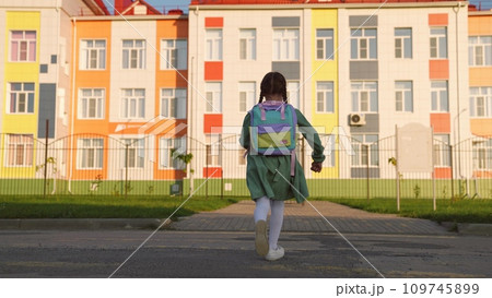 little girl with school backpack runs with her feet way to school. child daughter hurries knowledge lesson. heavy school bag shoulders running kid child. school childhood. children running outdoors. 109745899