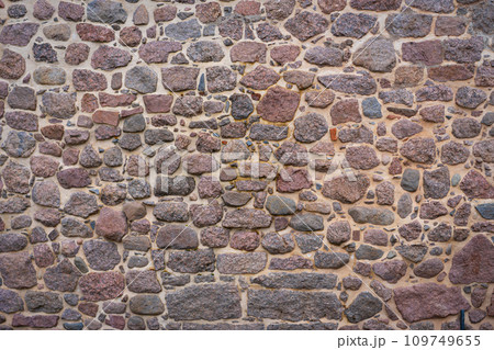 Old stone pavement background, abstract pavement, large cobblestones, old road texture. 109749655
