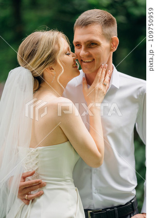Gentle and happy newlyweds on a walk in the park. 109750959