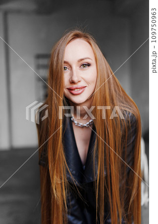 Portrait of a beautiful sexy young woman in a black leather shirt. 109750963
