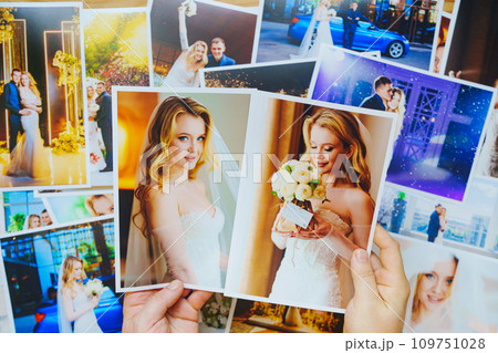 men's hands lay out Beautiful printed wedding photos. Professional photography. 109751028