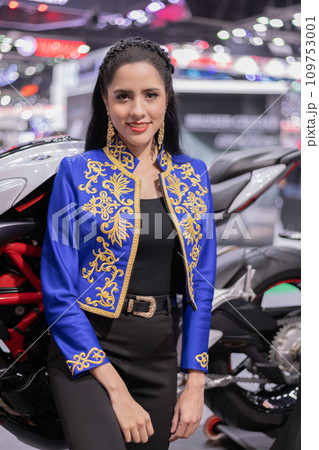 Caucasian man posing at car show in hall. Caucasian man posing at car show in hall. 109753001