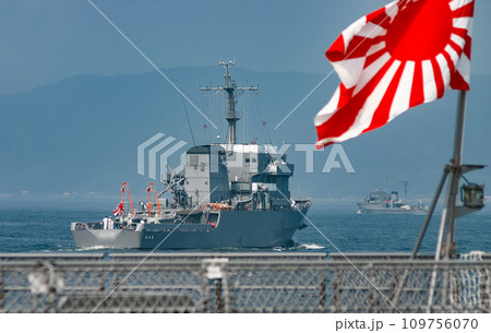 自衛艦旗の向こうで出港する海上自衛隊の多用途支援艦 109756070