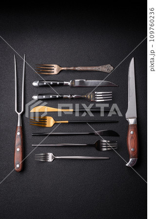 Kitchen knife and fork made of steel with copy space Kitchen knife and fork made of steel with copy space 109760236