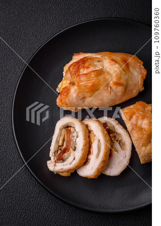 Delicious fresh meat roll made from chicken fillet, mushrooms, spices and herbs Delicious fresh meat roll made from chicken fillet, mushrooms, spices and herbs 109760360