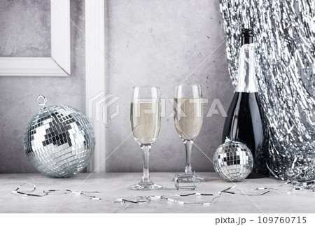 Glass of champagne with disco ball. 109760715