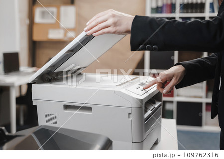 Business woman is using the printer to scanning Business woman is using the printer to scanning 109762316