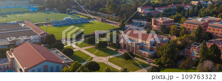 Aerial view of UCLA's campus, blending traditional and modern architecture, with a prominent stadium, greenery, and clear skies, conveying a serene academic atmosphere. Aerial view of UCLA's campus, blending traditional and modern architecture, with a prominent stadium, greenery, and clear skies, conveying a serene academic atmosphere. 109763322