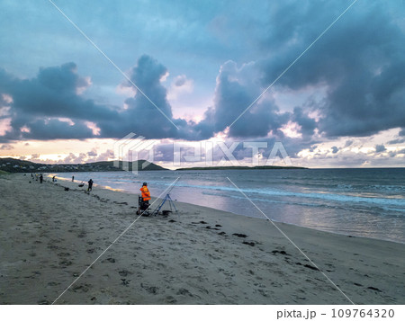 Fishing at Narin, Portnoo strand during amazing sunset in County Donegal - Ireland 109764320