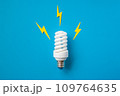 Light bulb with energy lightings on blue background 109764635