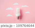 Light bulb with white cut out clouds. Idea concept 109764644