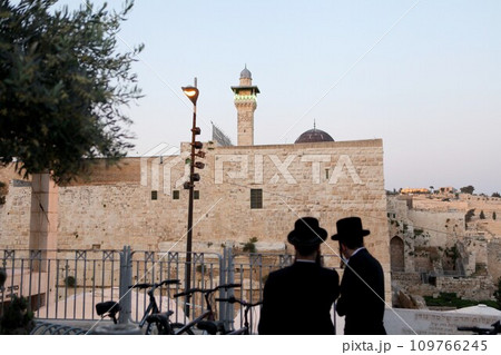 Western Wall and Worshipers in Jerusalem. The wall is one of the holiest sites in Judaism except for the Temple Mount itself. 109766245