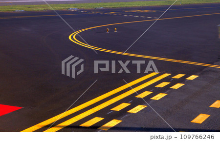 parking lot pavement at the airport with freshly painted yellow lines to mark the stalls. 109766246